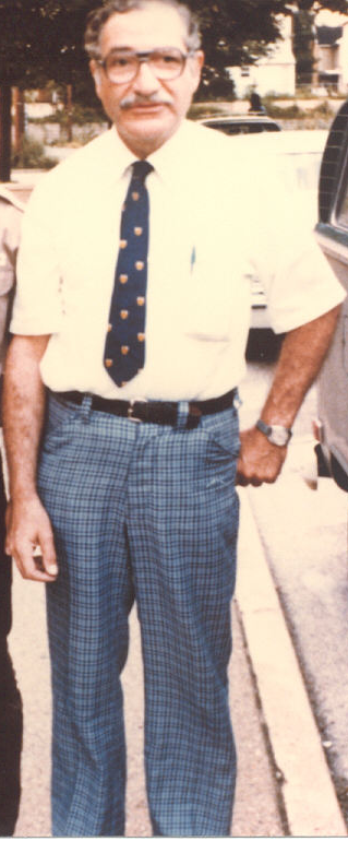 Dr. Edward I. Ciaccio outdoors in a short-sleeved shirt, tie, and plaid trousers.