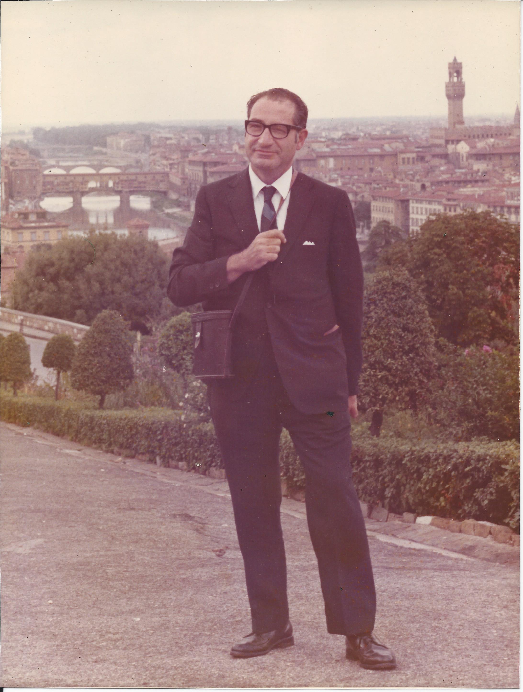 Dr. Edward I. Ciaccio standing in a suit overlooking Florence, Italy.